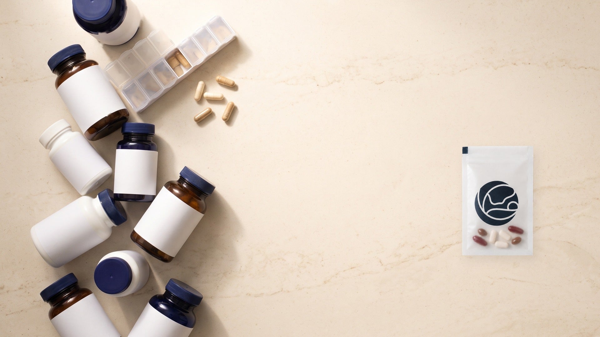 A counter holding a cluster of unlabelled supplement bottles and a weekly pill organiser on the left, and a single Mothersense sachet on the right